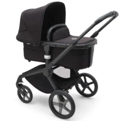 Bugaboo Fox 5 Travel System - Black/Midnight Black Base With Sun Canopy 35 Bugaboo Fox 5 Travel System - Black/Midnight Black Base With Sun Canopy -Baby Products Series LargeJPG 100167008 fox5 black bassinet black midnight black sideshot 3e1857f9 a462 4937 8fa4 6830e7948062