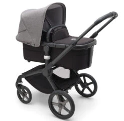 Bugaboo Fox 5 Travel System - Black/Midnight Black Base With Sun Canopy 31 Bugaboo Fox 5 Travel System - Black/Midnight Black Base With Sun Canopy -Baby Products Series LargeJPG 100167012 fox5 black bassinet black grey melange sideshot a122305e eb39 44df 86f2 eecedfbfe7af